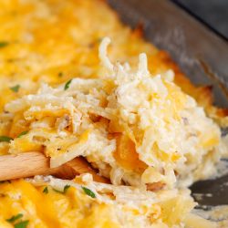 Cheesy hashbrown casserole in a pan.