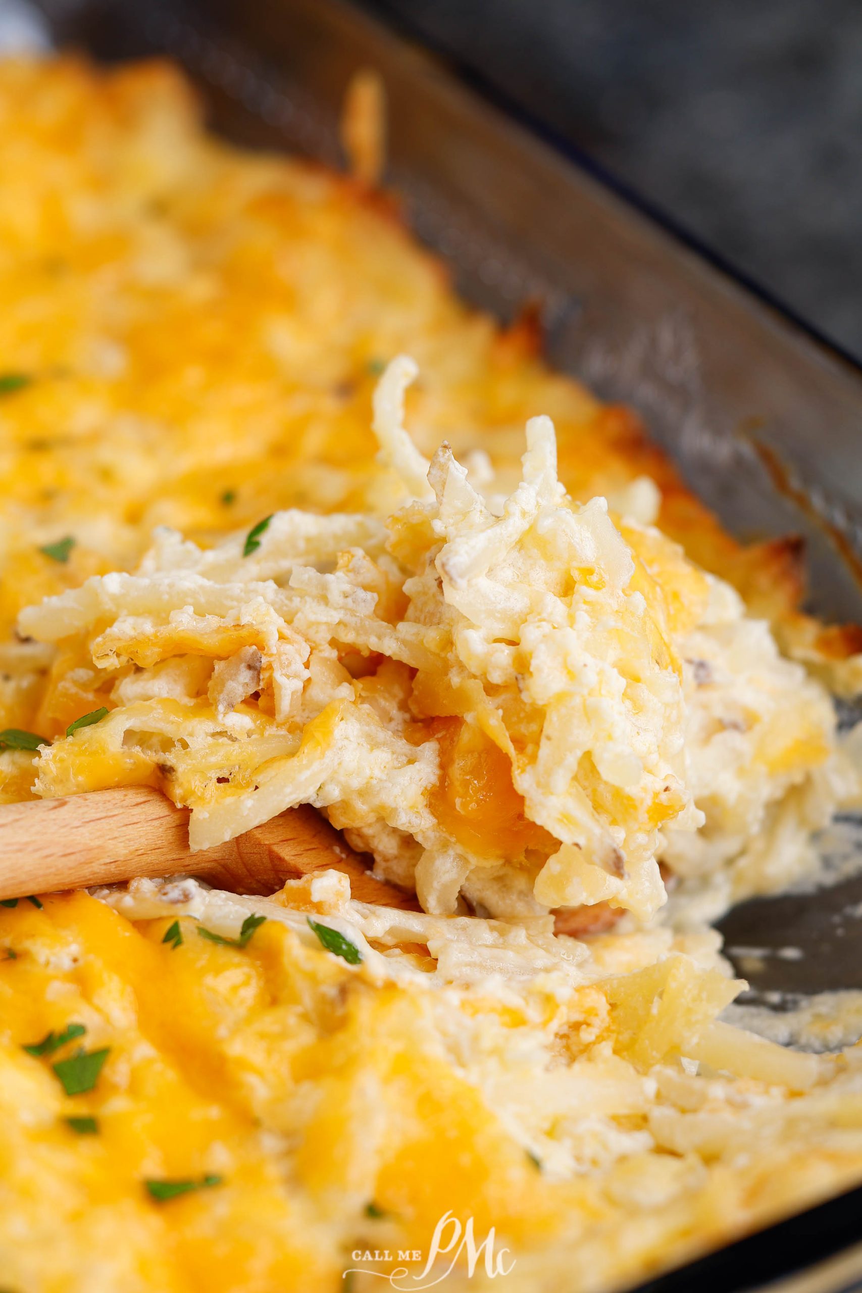 Cheesy hashbrown casserole in a pan.