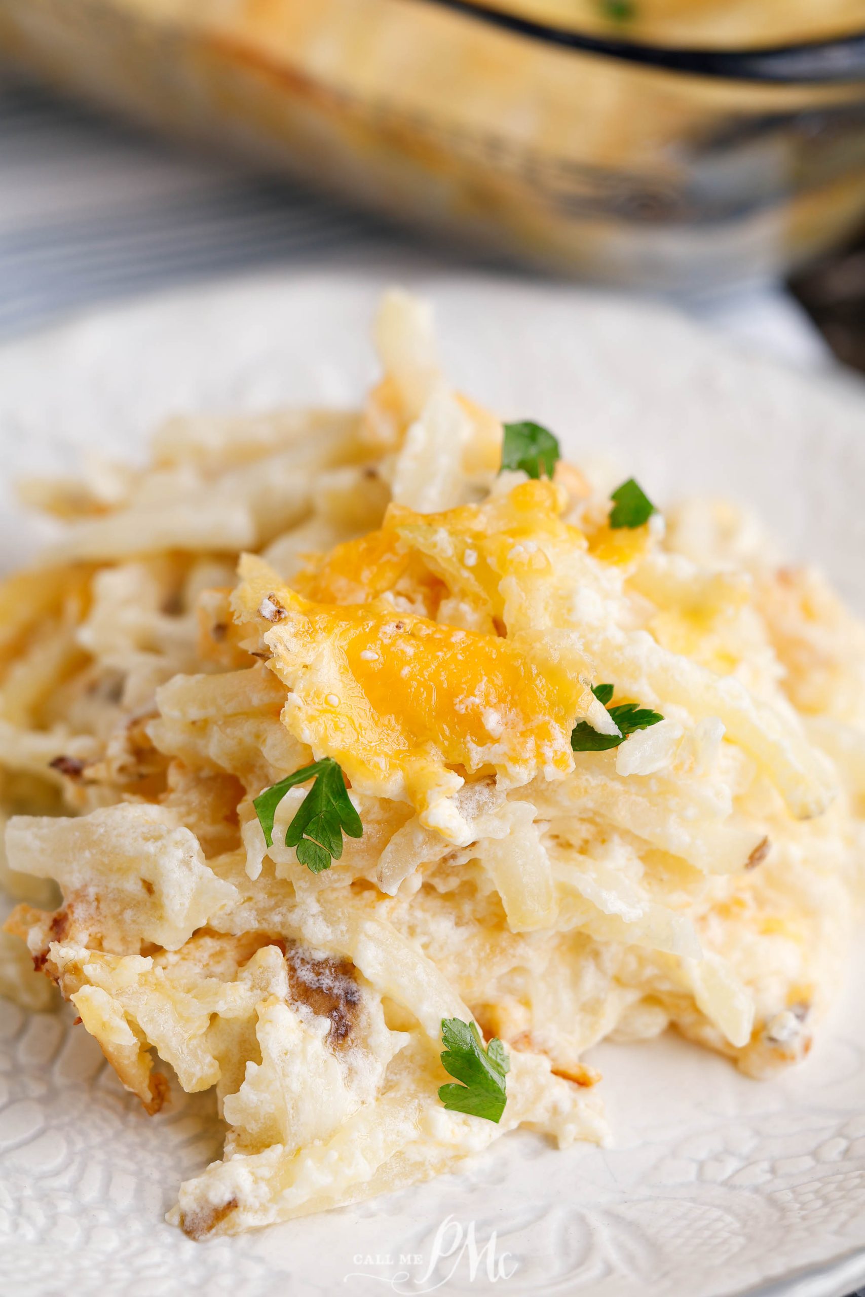 Cheesy hashbrown casserole in a pan.