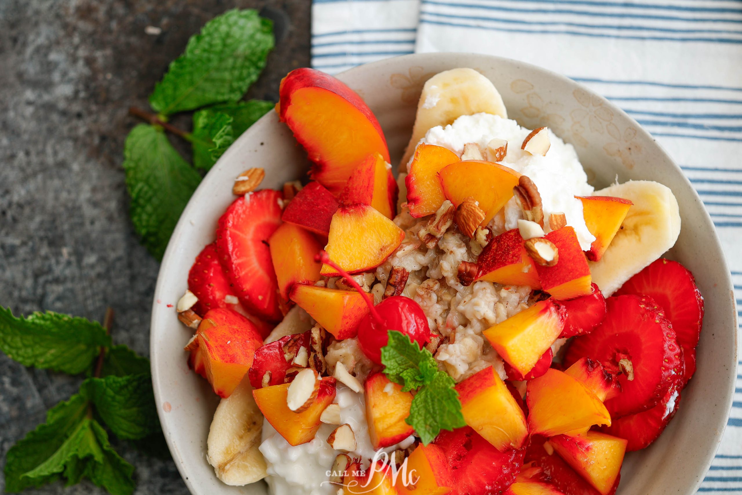 A bowl of bananas, strawberries and whipped cream.