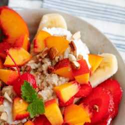 A plate topped with bananas, strawberries and granola.