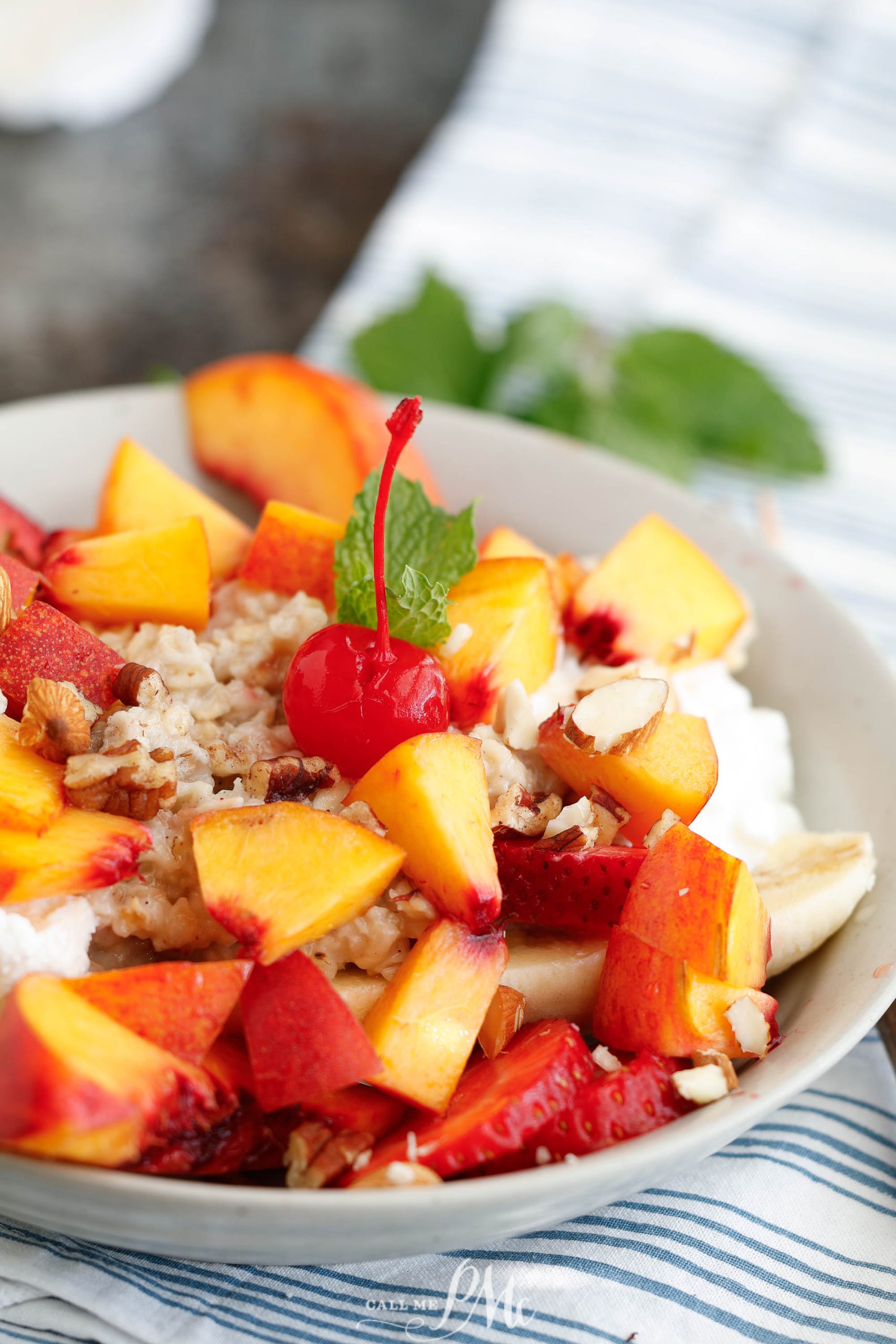 A plate of fruit and yogurt on a table.