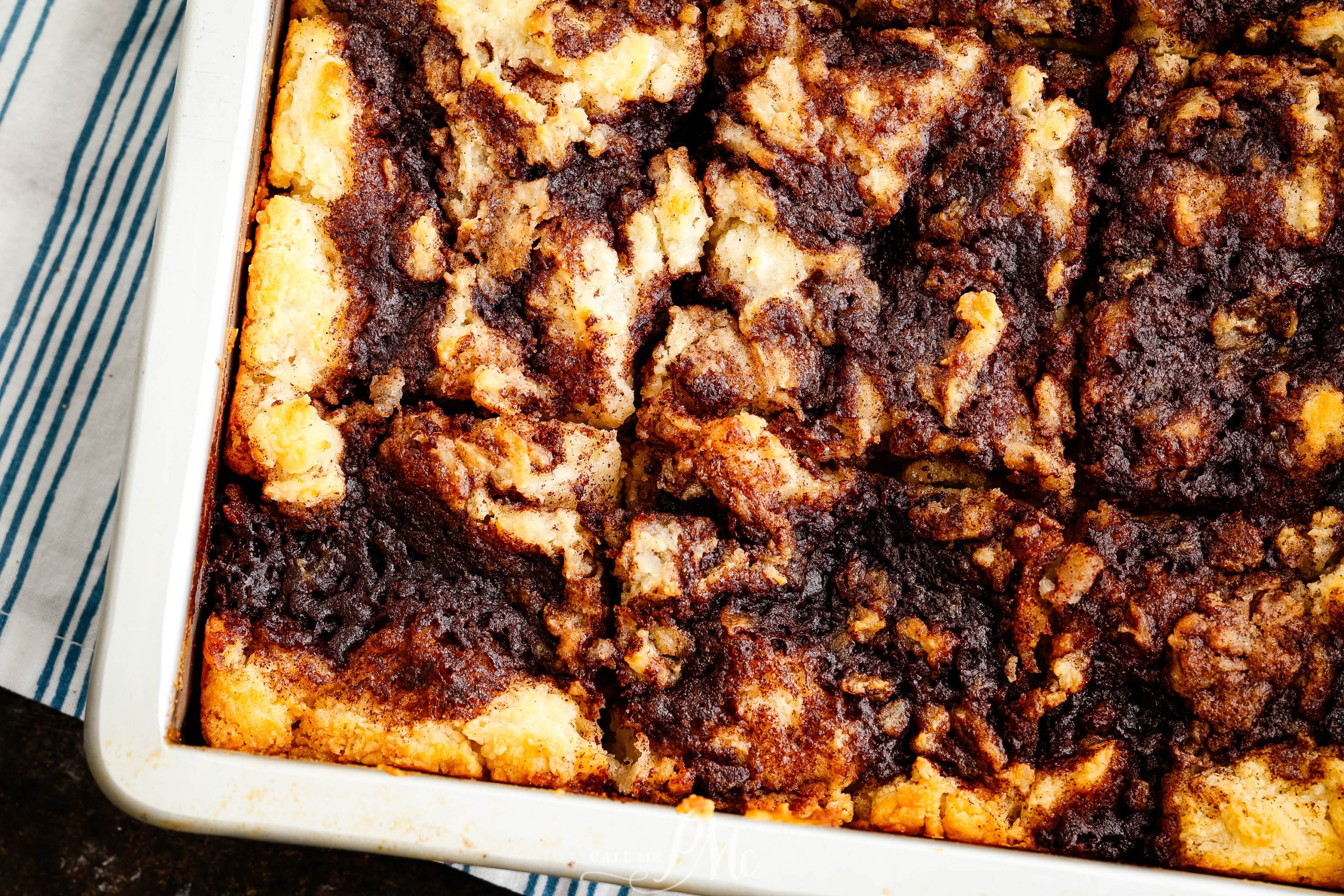 A baking dish with a piece of Butter Swim Cinnamon Biscuits.