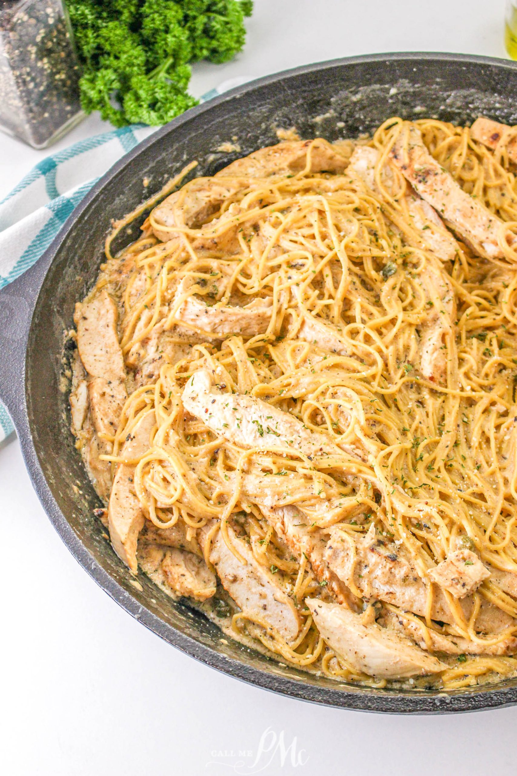 A skillet filled with Chicken Caesar Angel Hair Pasta.