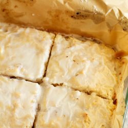 A baking dish with a piece of cinnamon roll cake in it.