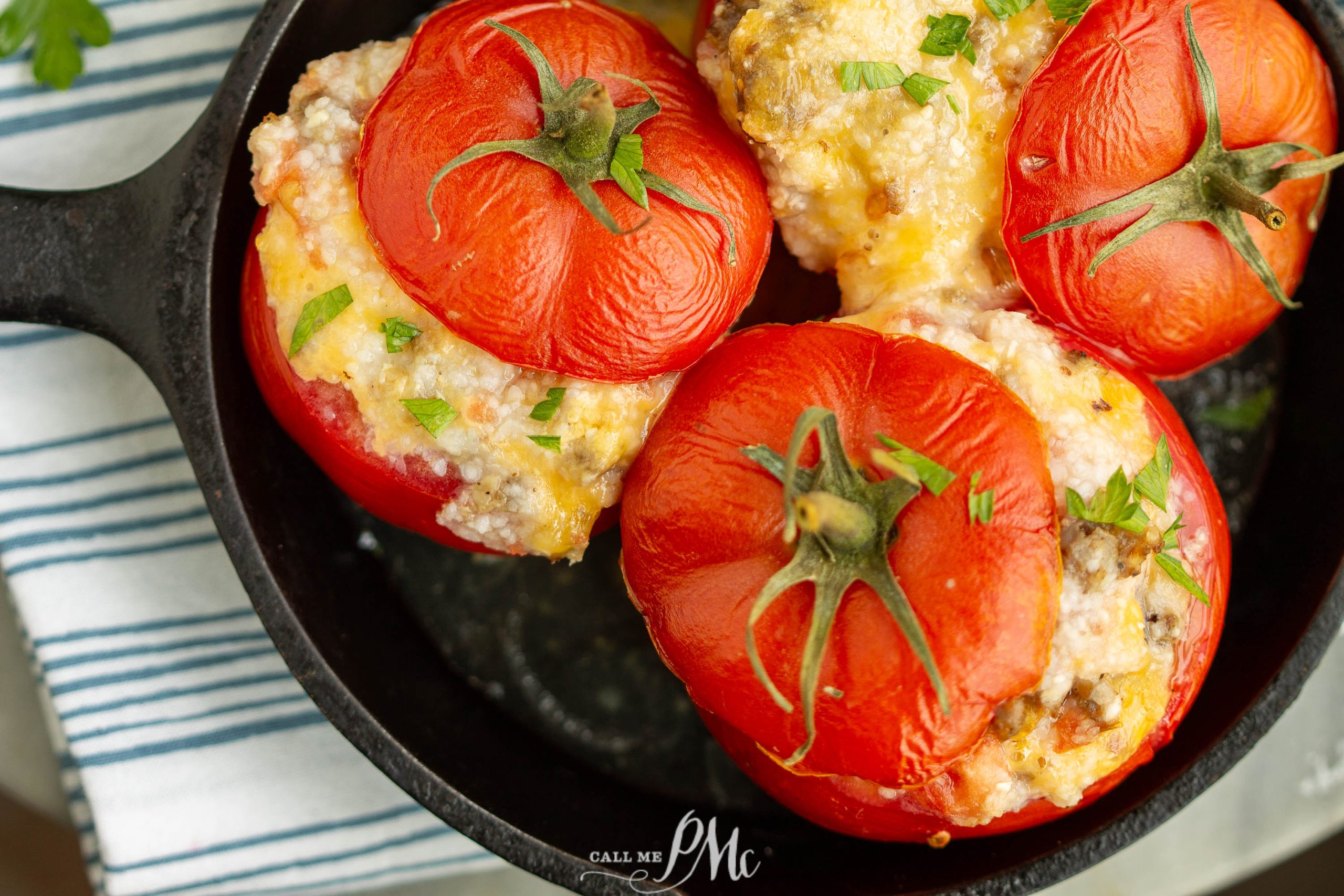 Stuffed tomatoes in a cast iron skillet.