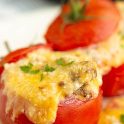 Cheesy stuffed tomatoes on a plate.