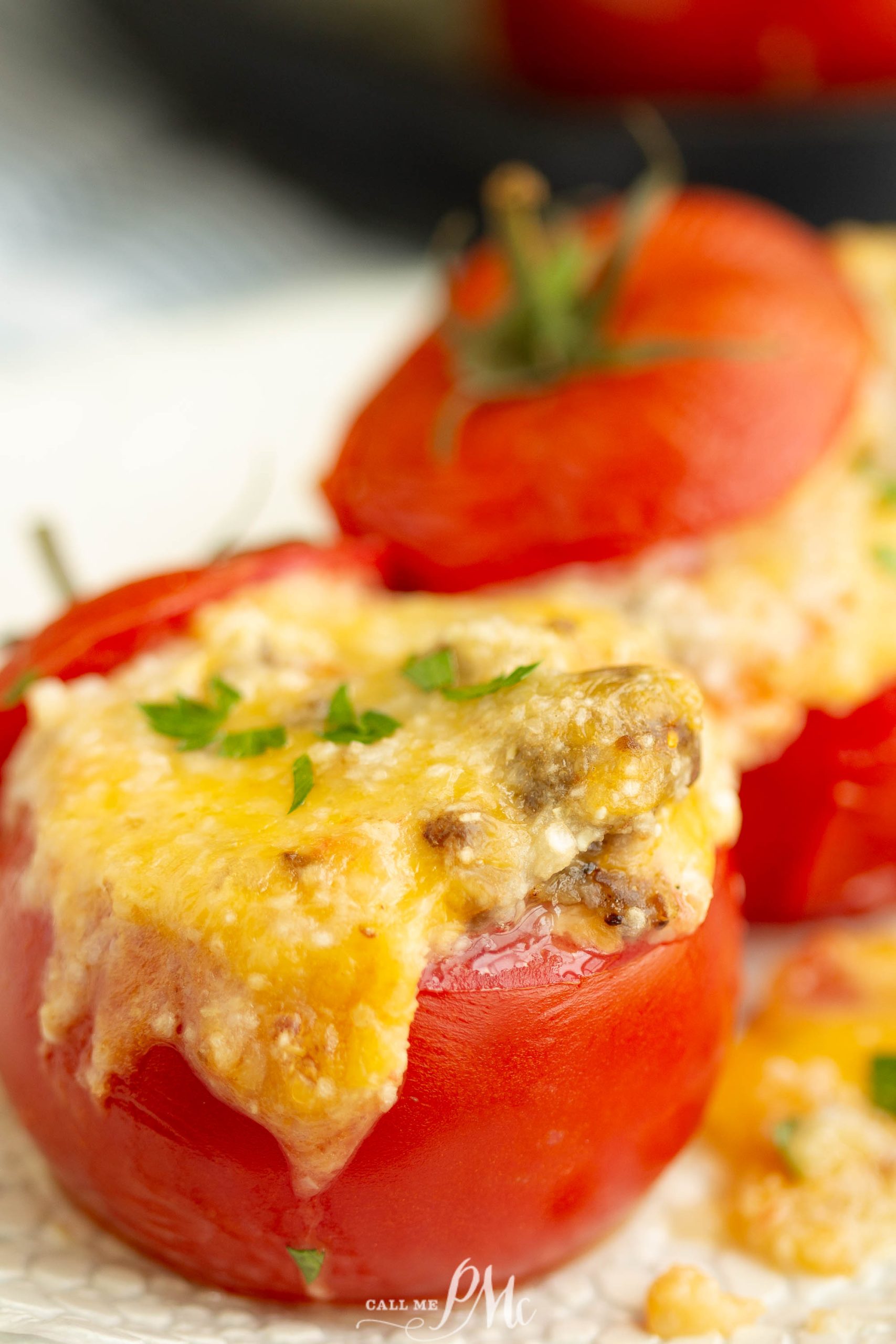 Cheesy stuffed tomatoes on a plate.