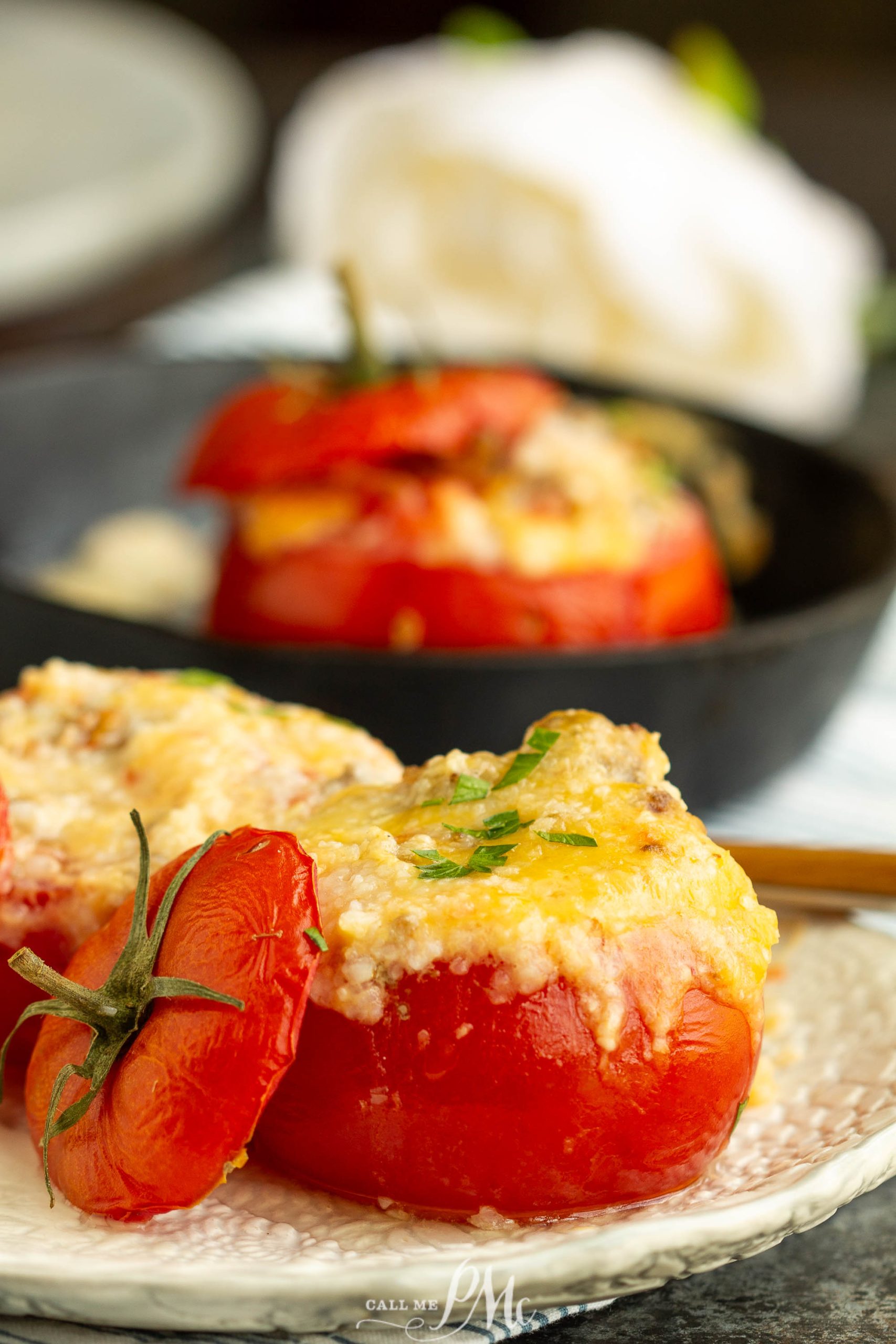 Grits Casserole Stuffed Baked Tomatoes, Stuffed tomatoes with cheese and herbs on a plate.