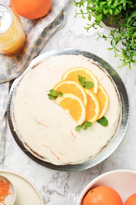 Semi Naked Orange Cake. A pie with orange slices and mint on a plate.