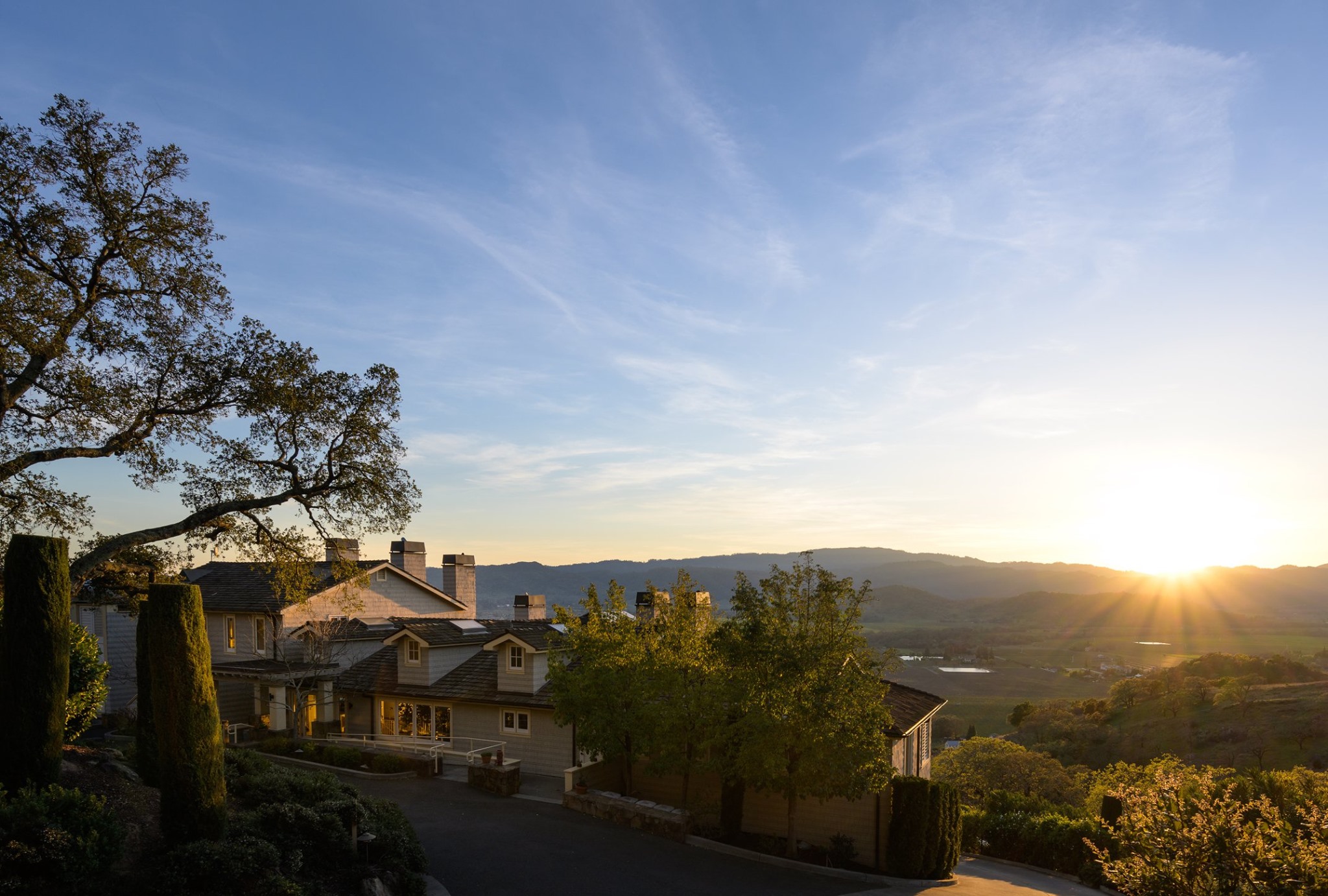 The sun is setting over Poetry Inn in Napa Valley.
