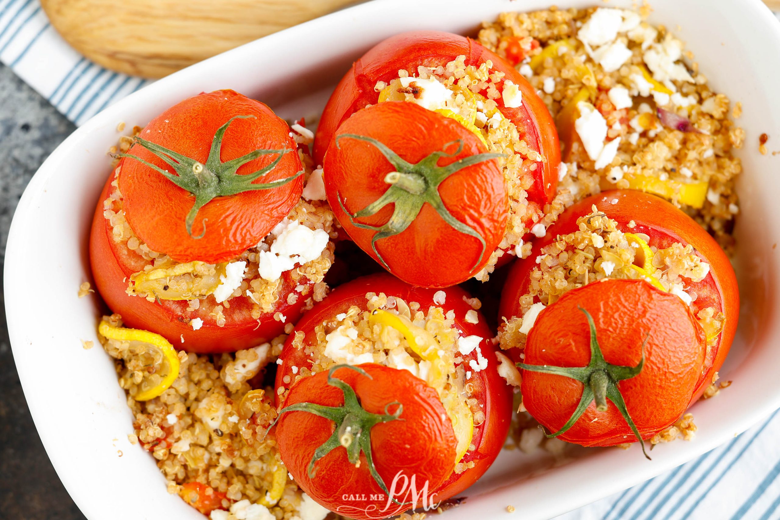 Flatlay of stuffed tomatoes with 'lids' on.