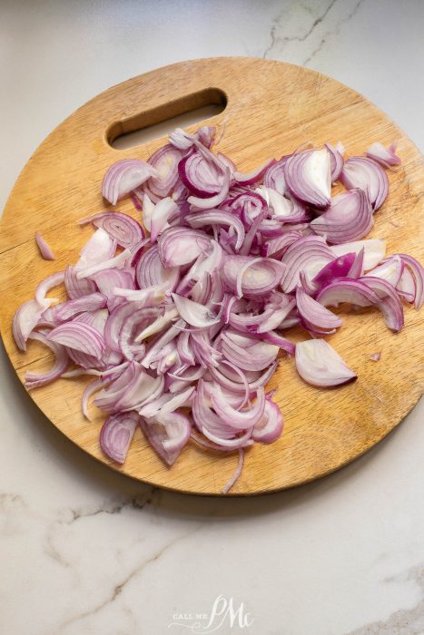 Chopped red onions on a cutting board.