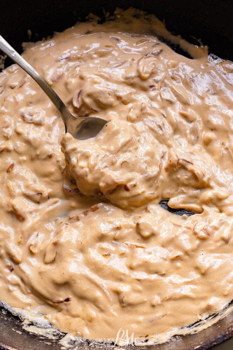 cheese sauce in a pan with a spoon.