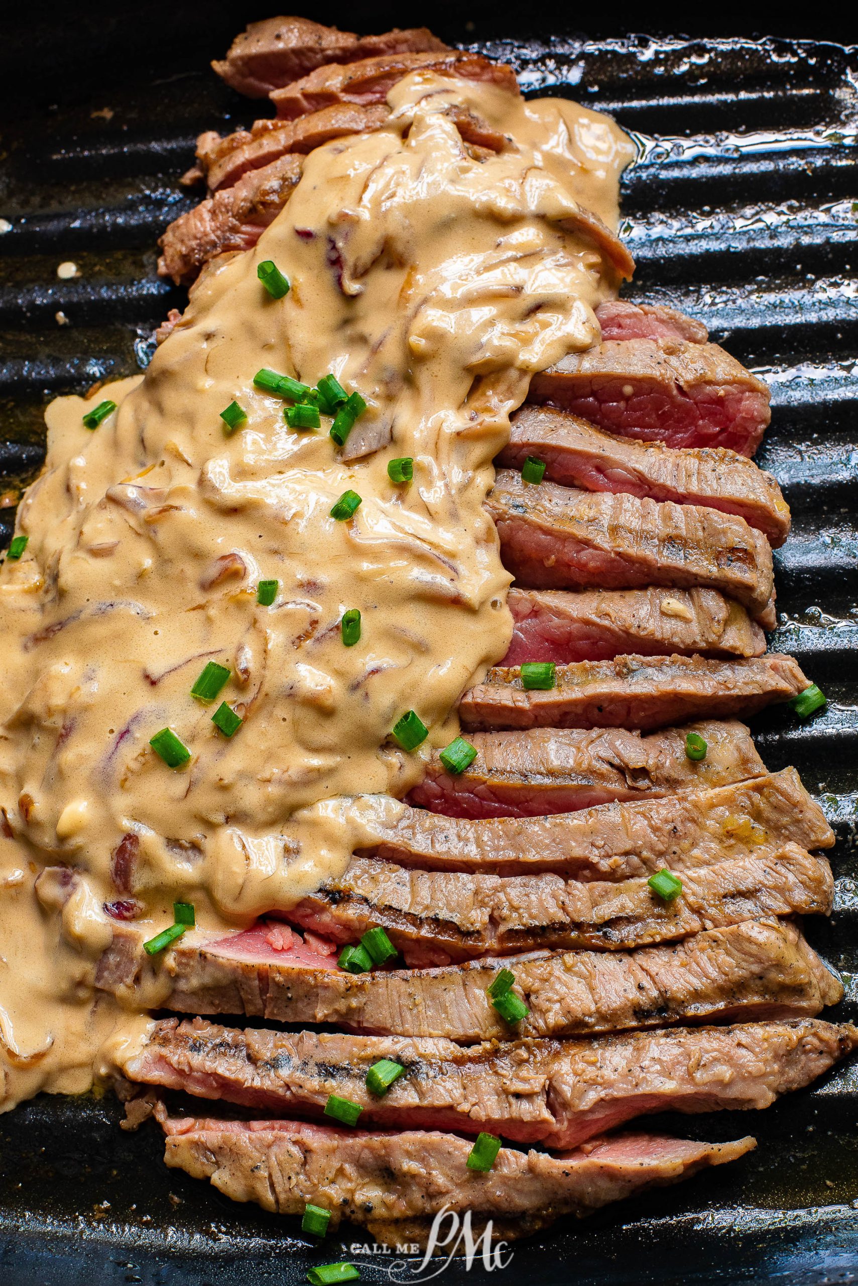 Ribeye with Feta Gravy. A steak on a grill with a sauce on it.