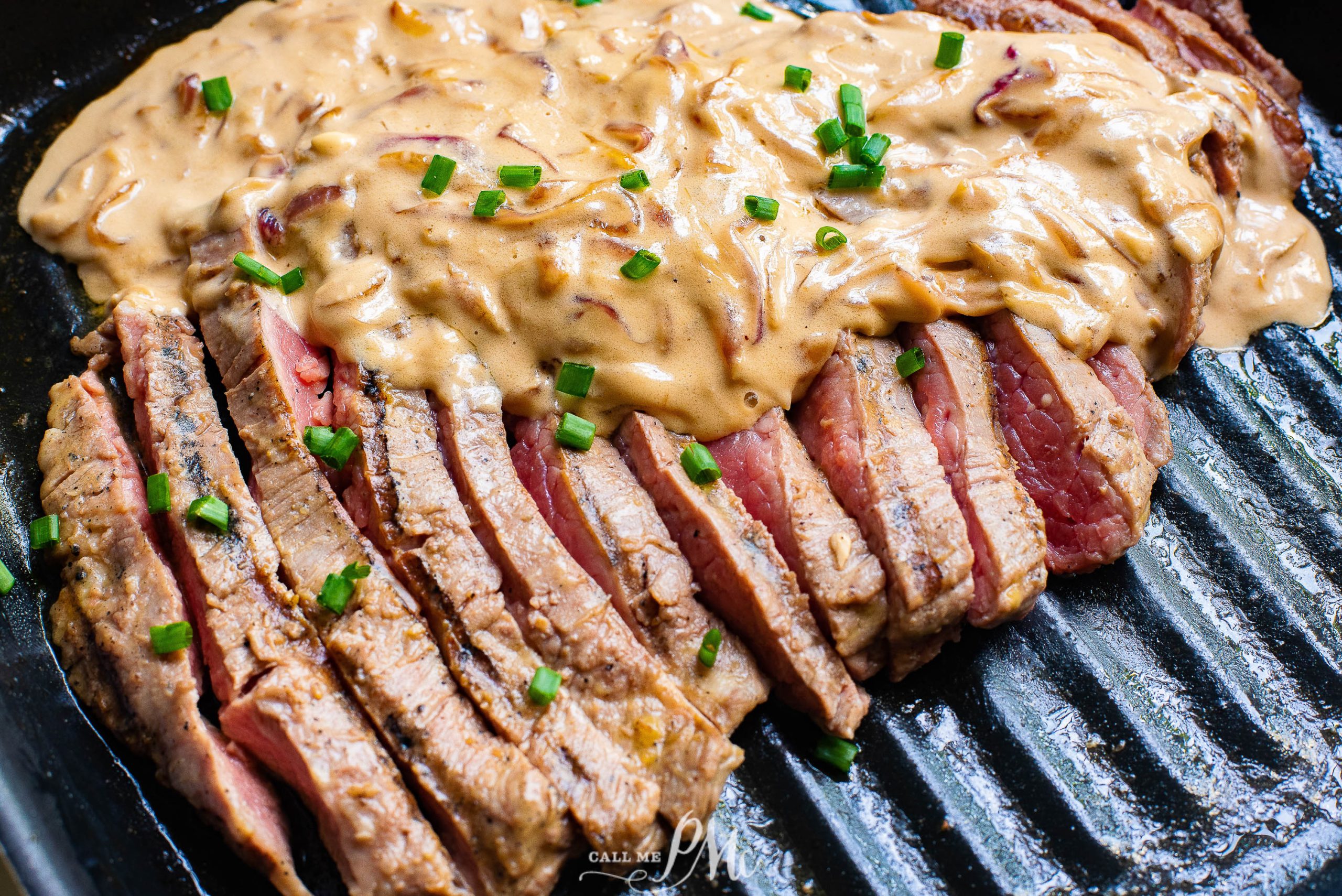 Ribeye with Feta Gravy, A steak on a grill with a sauce on it.