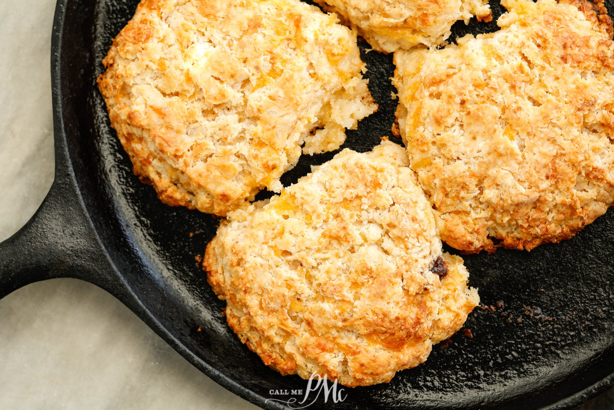 Small Batch Cheddar Biscuits in a cast iron skillet.