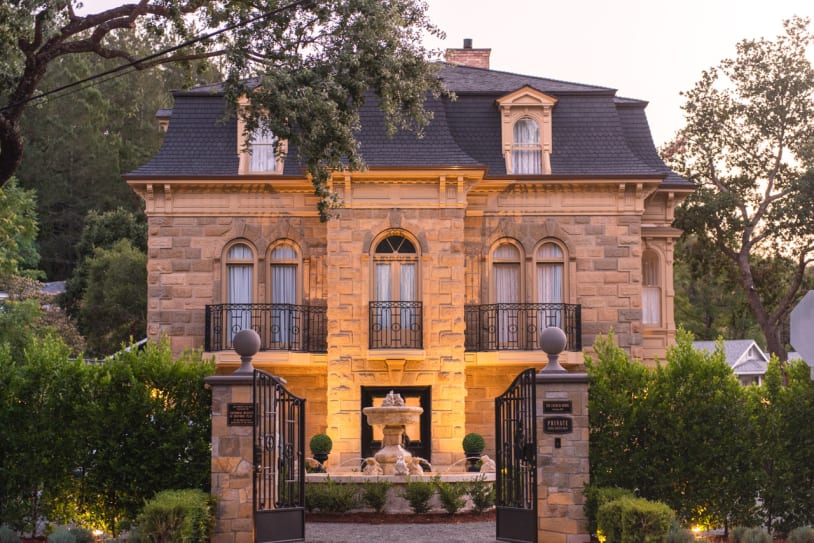 the Francis House with lights and fountain in front of it.