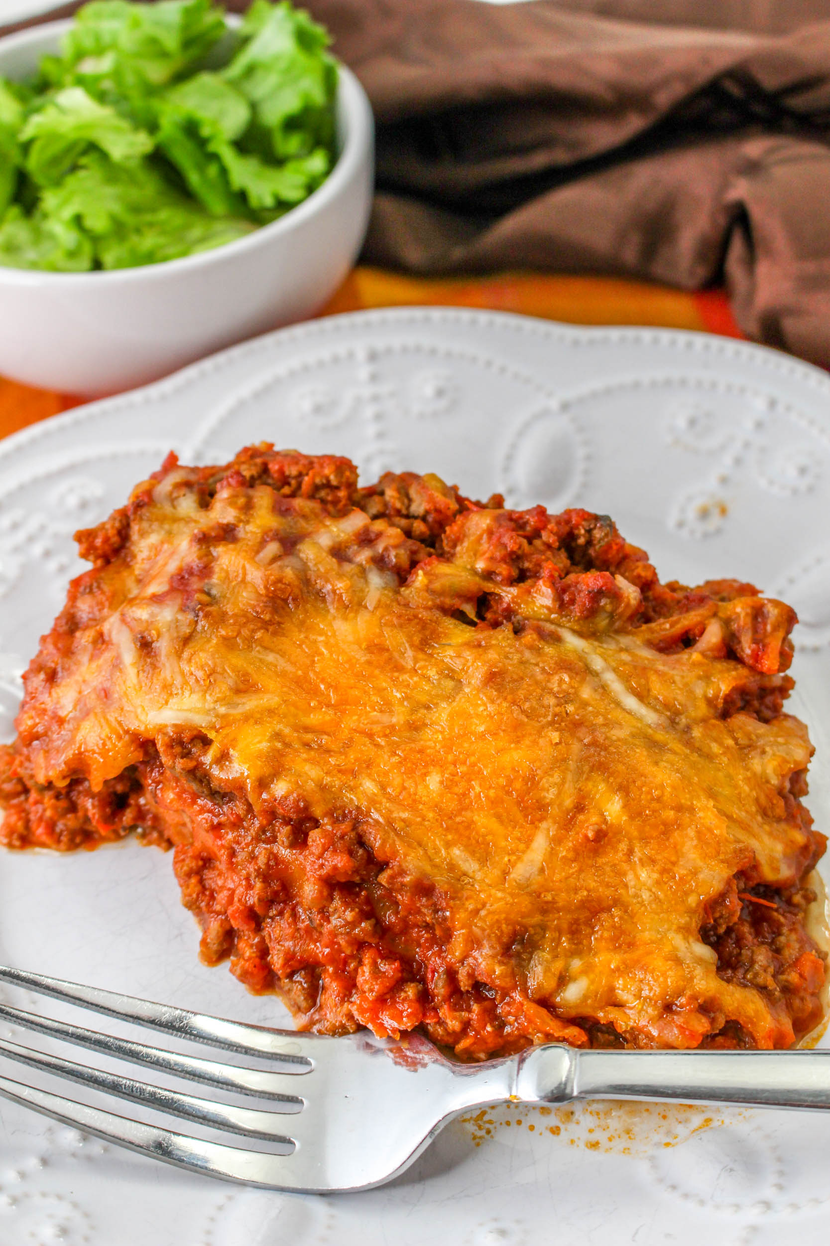 Tiktok Texas Toast Casserole, Mexican lasagna on a plate with a fork.