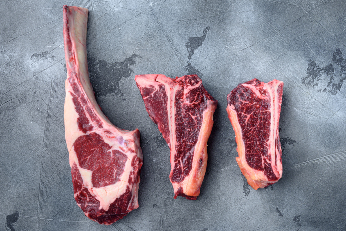 Three cuts of dry aged steak on a counter