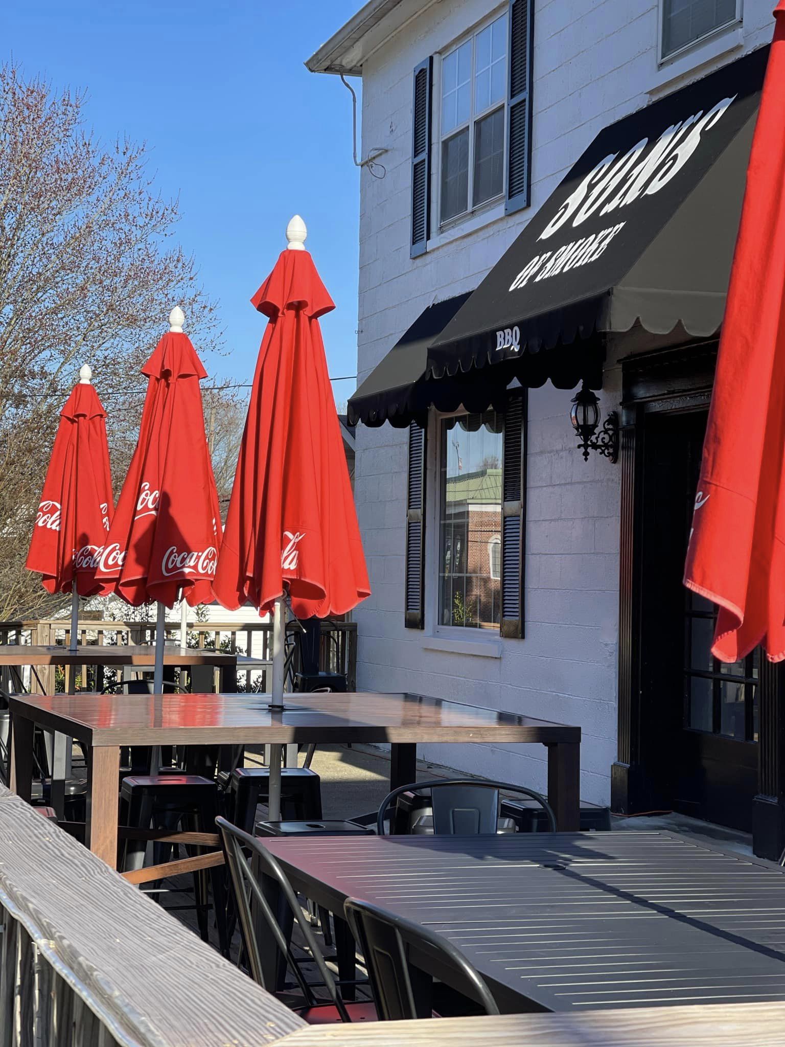 Red umbrellas on the patio of a restaurant.