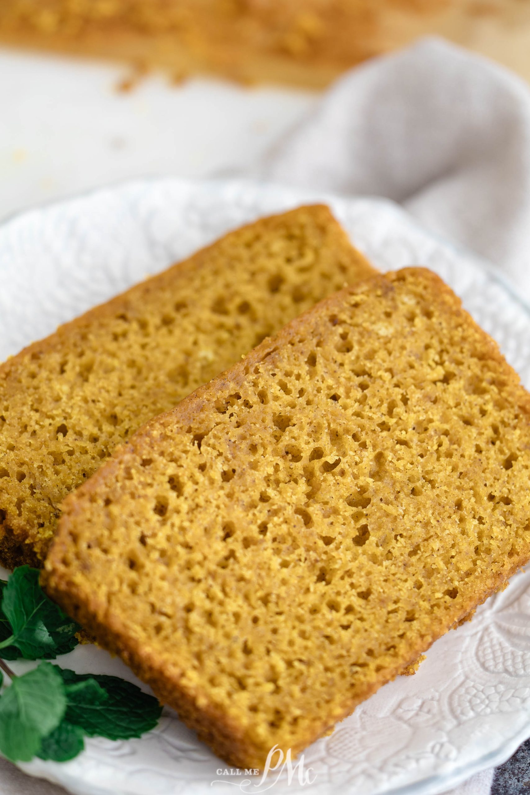 Two slices of Cake Mix Pumpkin Loaf on a plate.