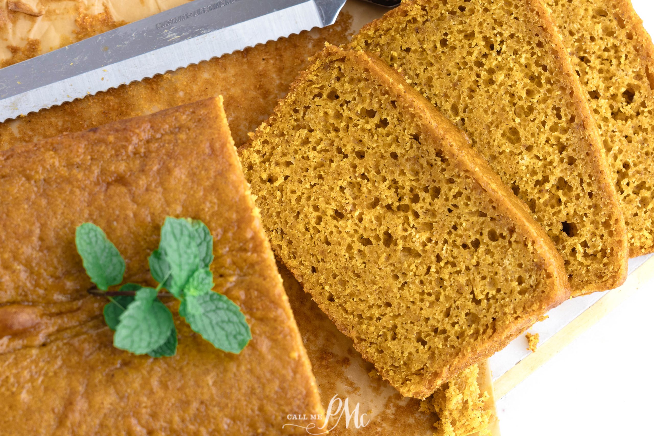 Cake Mix Pumpkin Loaf on a cutting board with a knife.