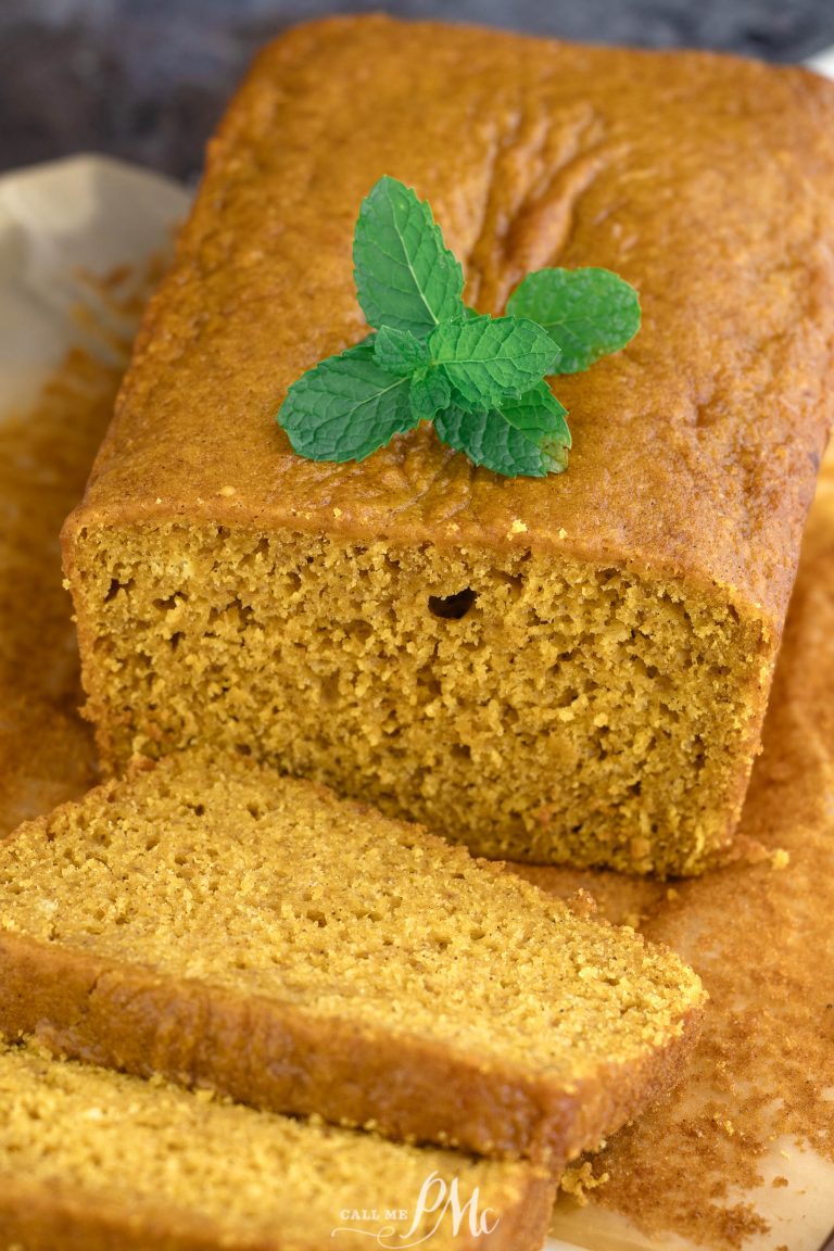 A slice of pumpkin bread with a mint leaf on top.