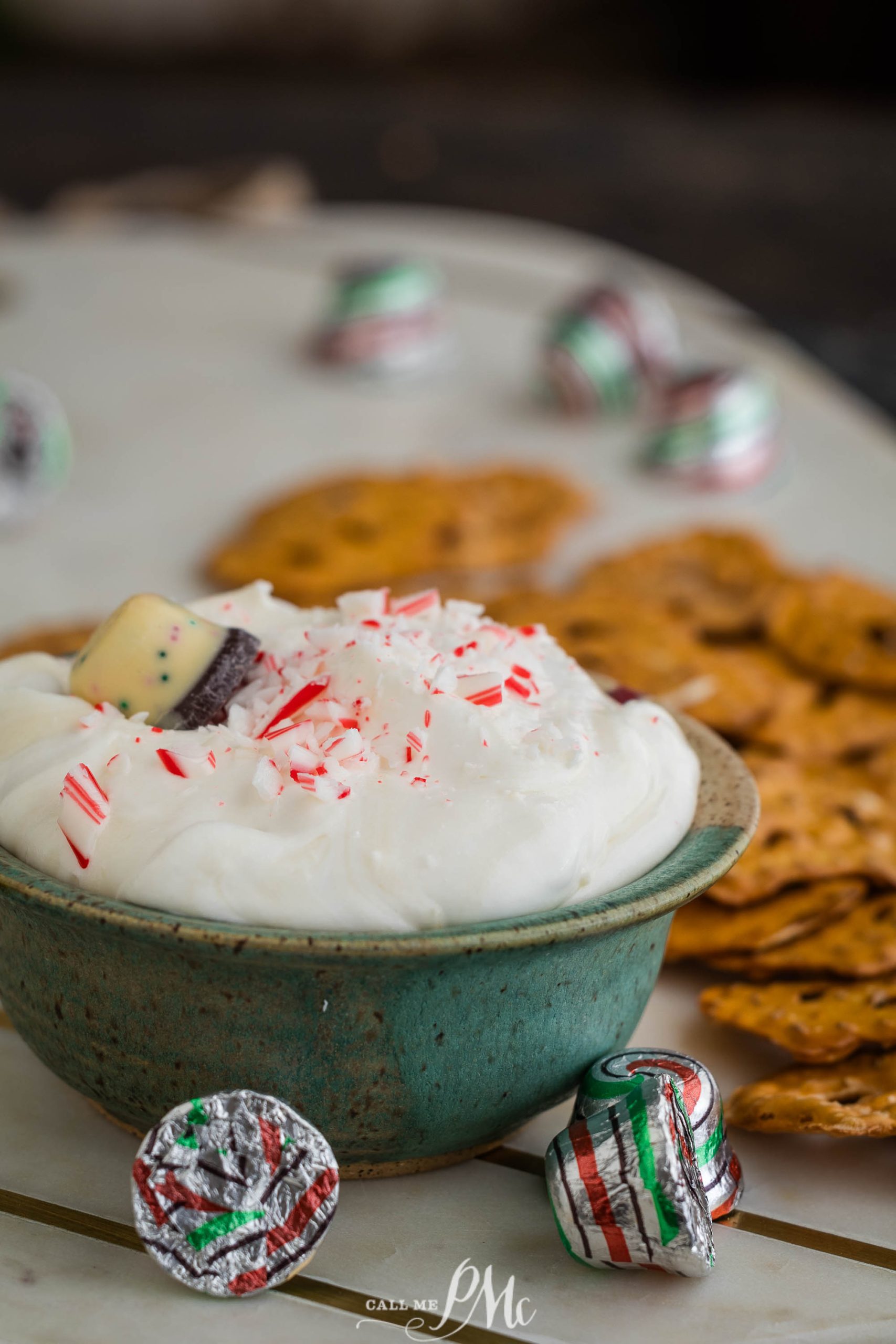 A bowl of peppermint dip surrounded by candy canes.