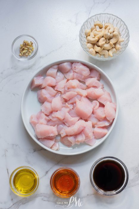 Chicken with cashews and cashew nuts on a white plate.