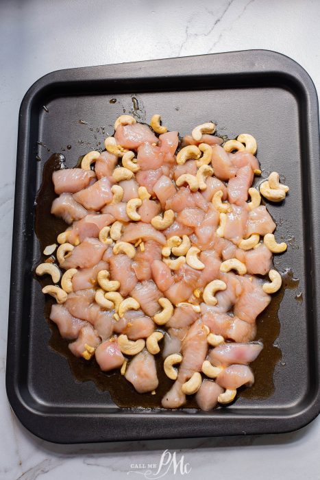 Sheet Pan Honey Soy Cashew Chicken on a baking sheet with cashew nuts.