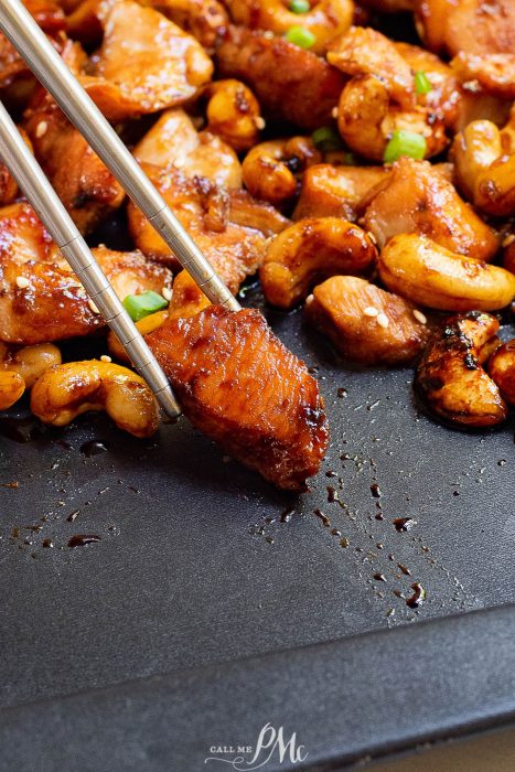 Chinese chicken on a pan with chopsticks.