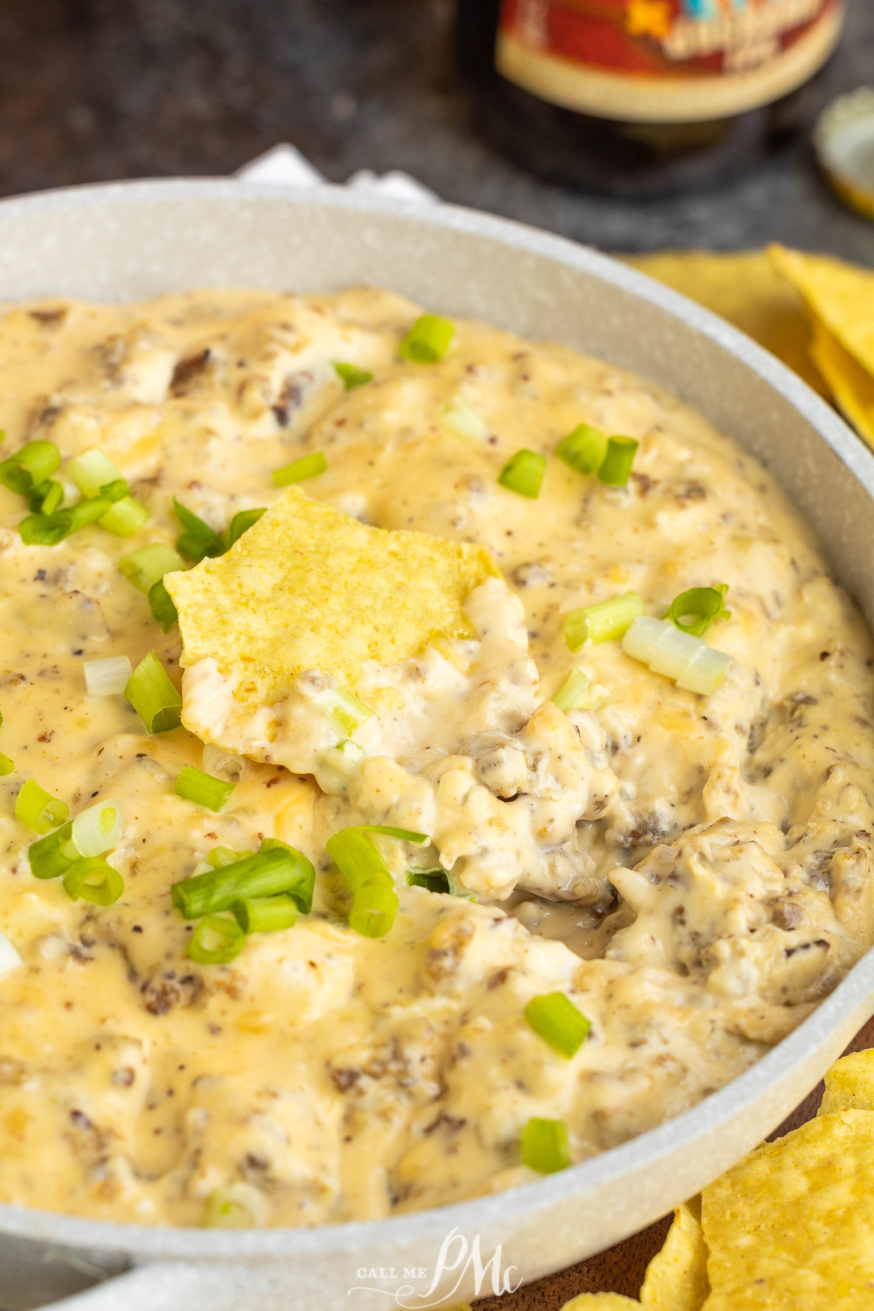 A bowl of Better Hissy Fit Dip with chips and a bottle of beer.