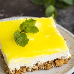 A slice of lemon cheesecake on a plate.