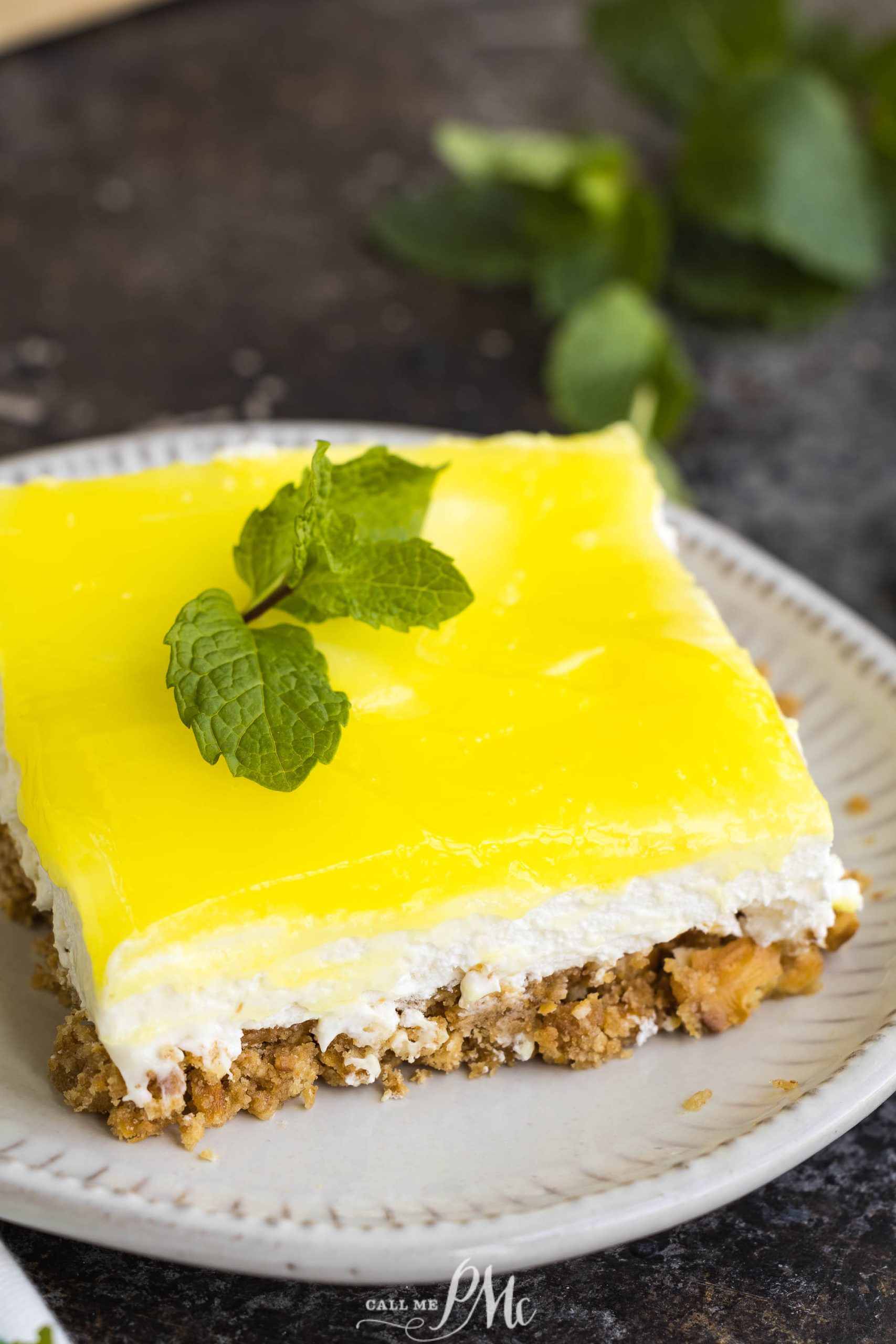 A slice of lemon cheesecake on a plate.
