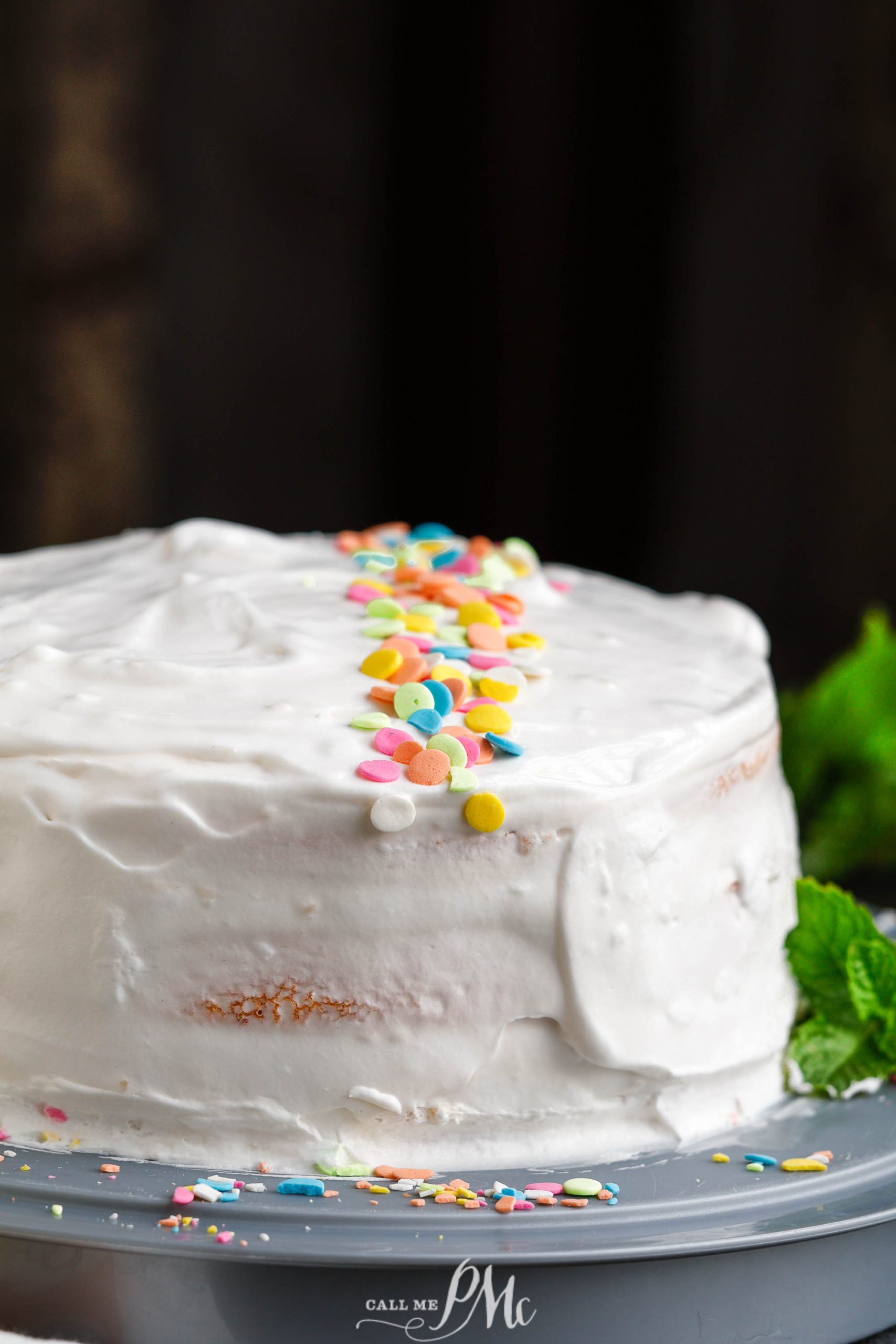 A Peach Jello Layer Cake with sprinkles on top.