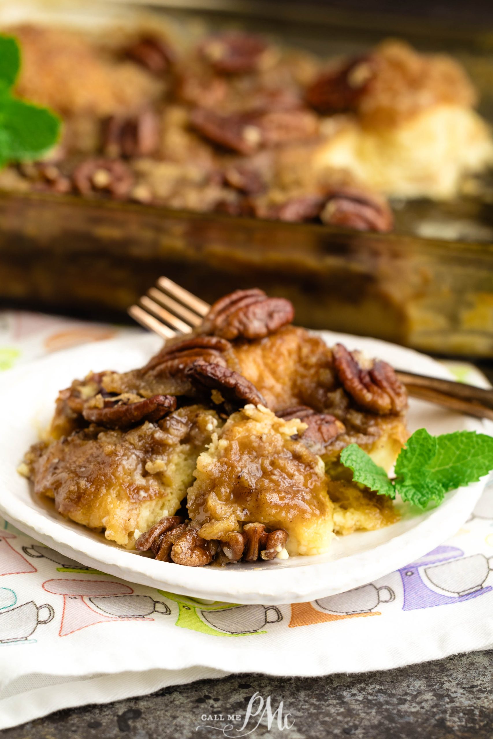 Pecan coffee cake on a plate with a fork.