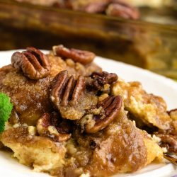 French toast casserole with pecans on a plate.