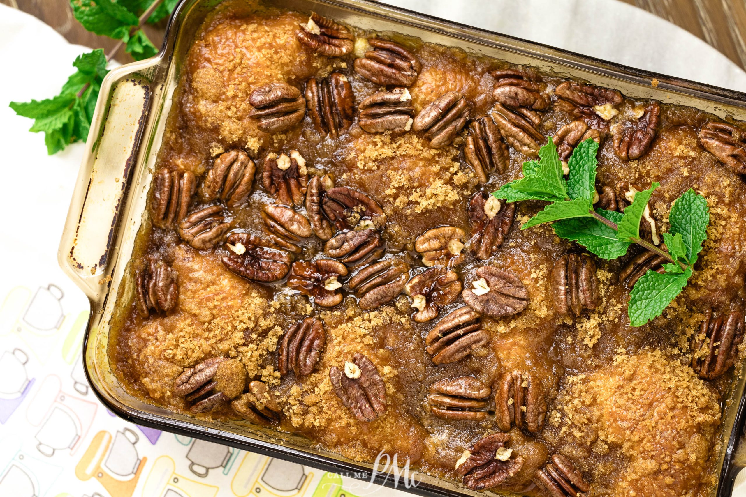Bread Pudding in a baking dish with pecans and mint.