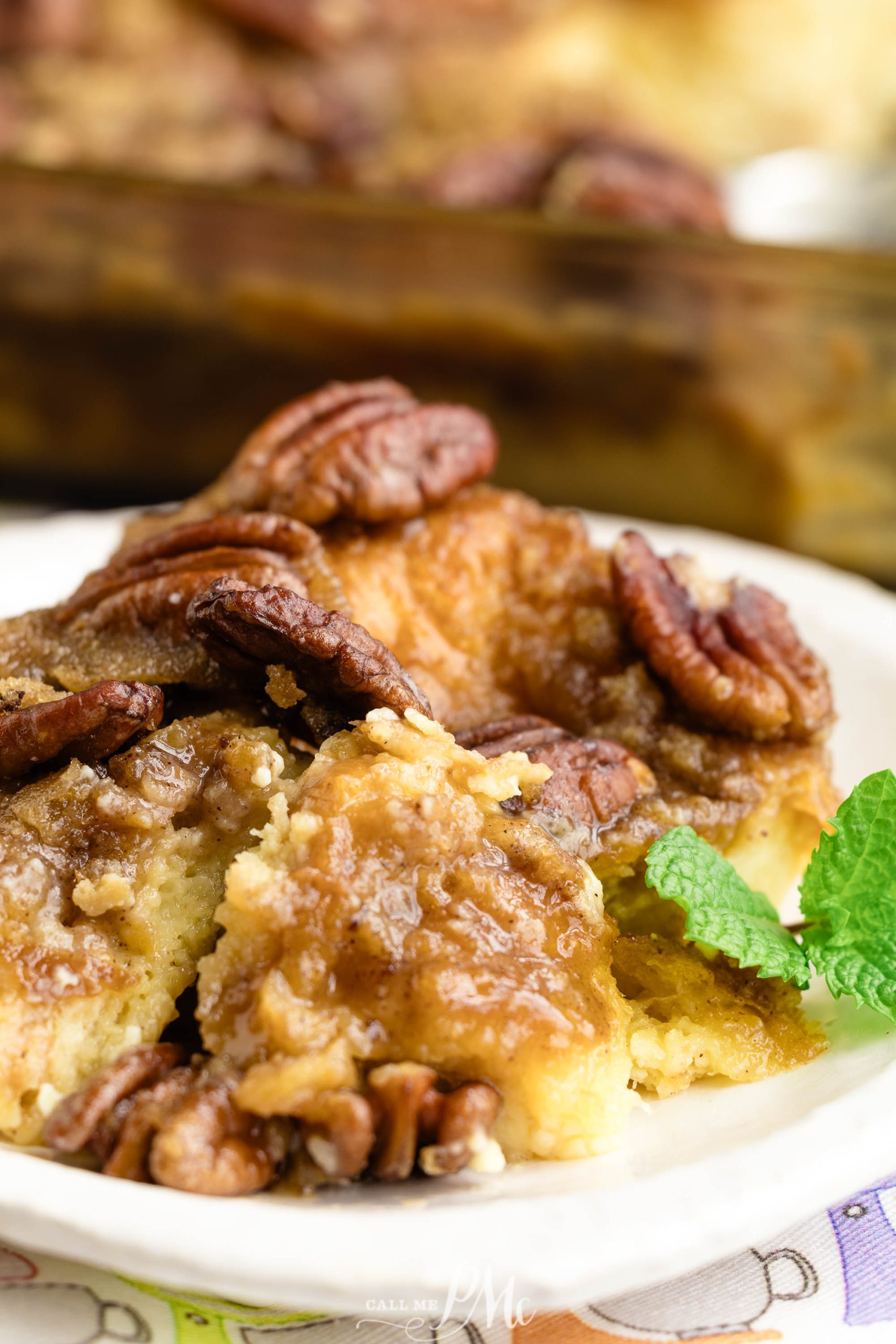 Praline Croissant Bread Pudding with pecans on a plate.
