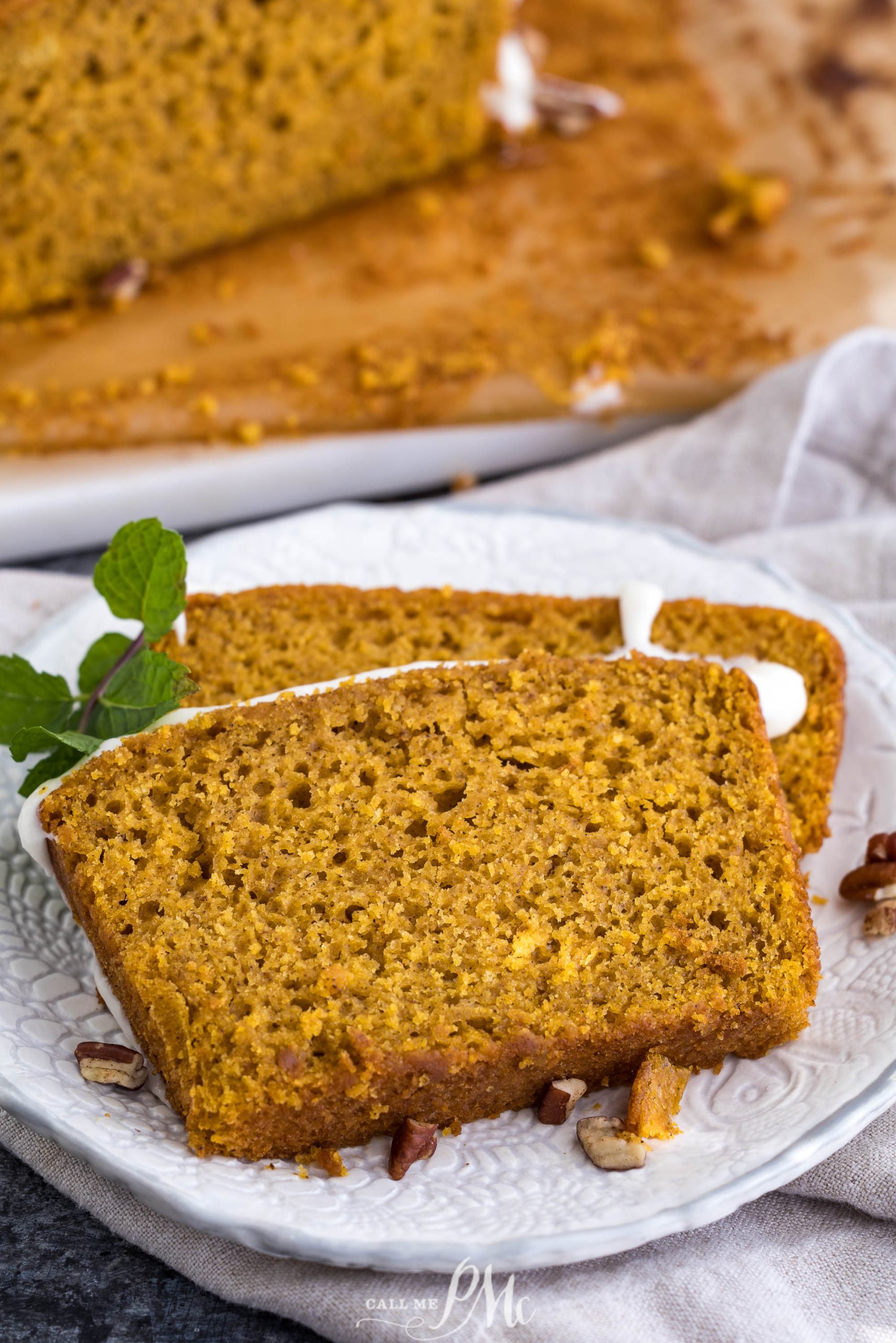 A slice of Pumpkin Loaf with Cream Cheese Glaze on a plate