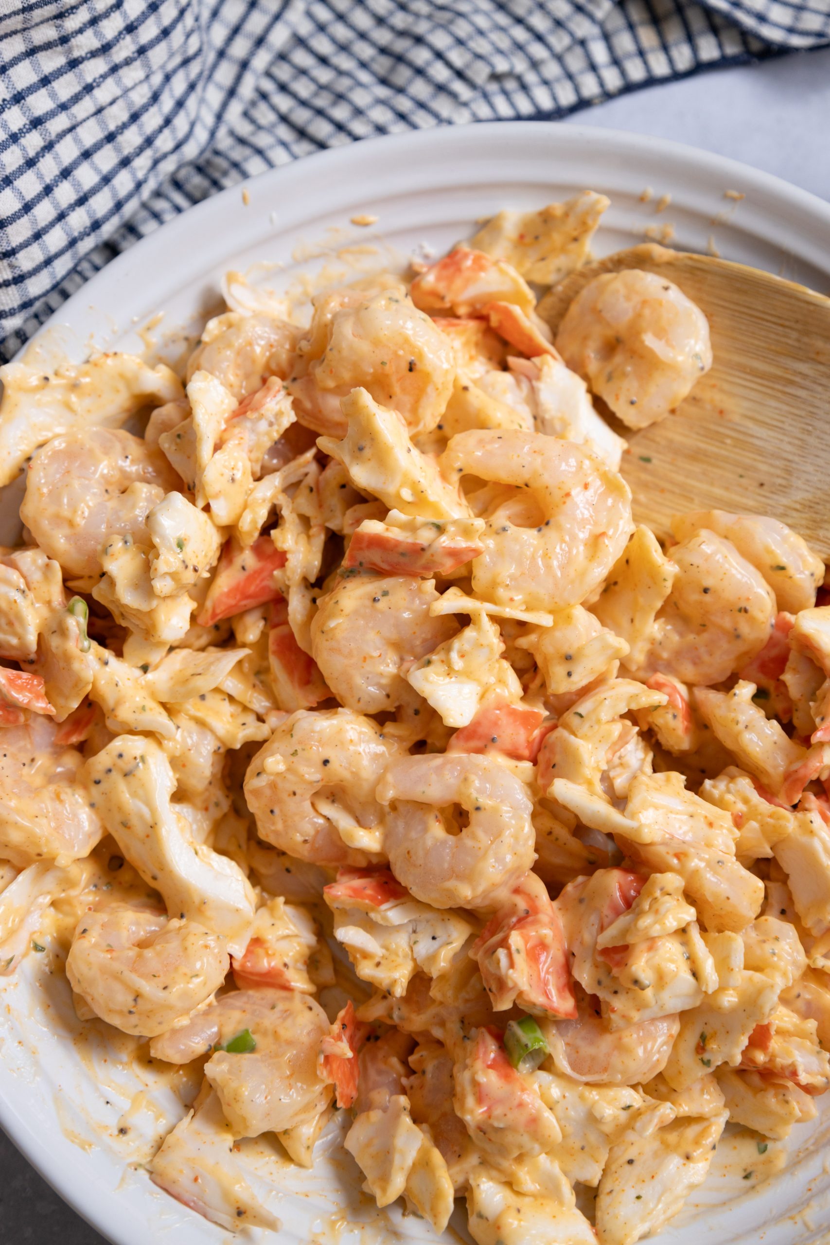 Light Shrimp and Crab Remoulade on a plate with a wooden spoon.