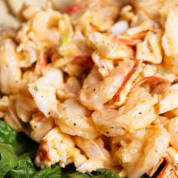 Shrimp salad on a plate with crackers.