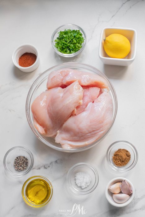 Chicken breast ingredients in a bowl on a marble countertop.