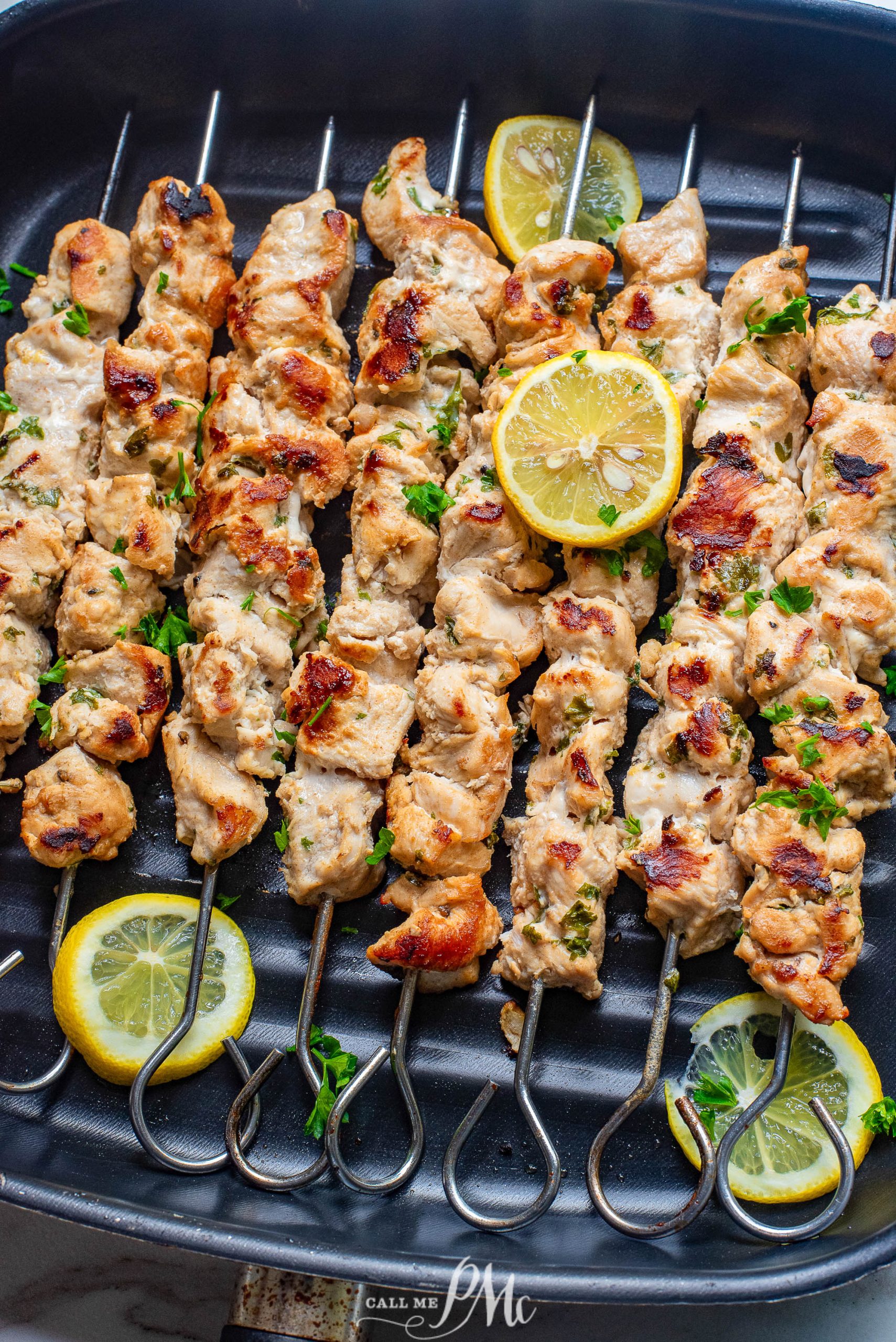 🎉Stovetop Chicken Souvlaki on a grill with lemon wedges.