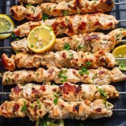 🎉Stovetop Chicken Souvlaki on a grill with lemon wedges.