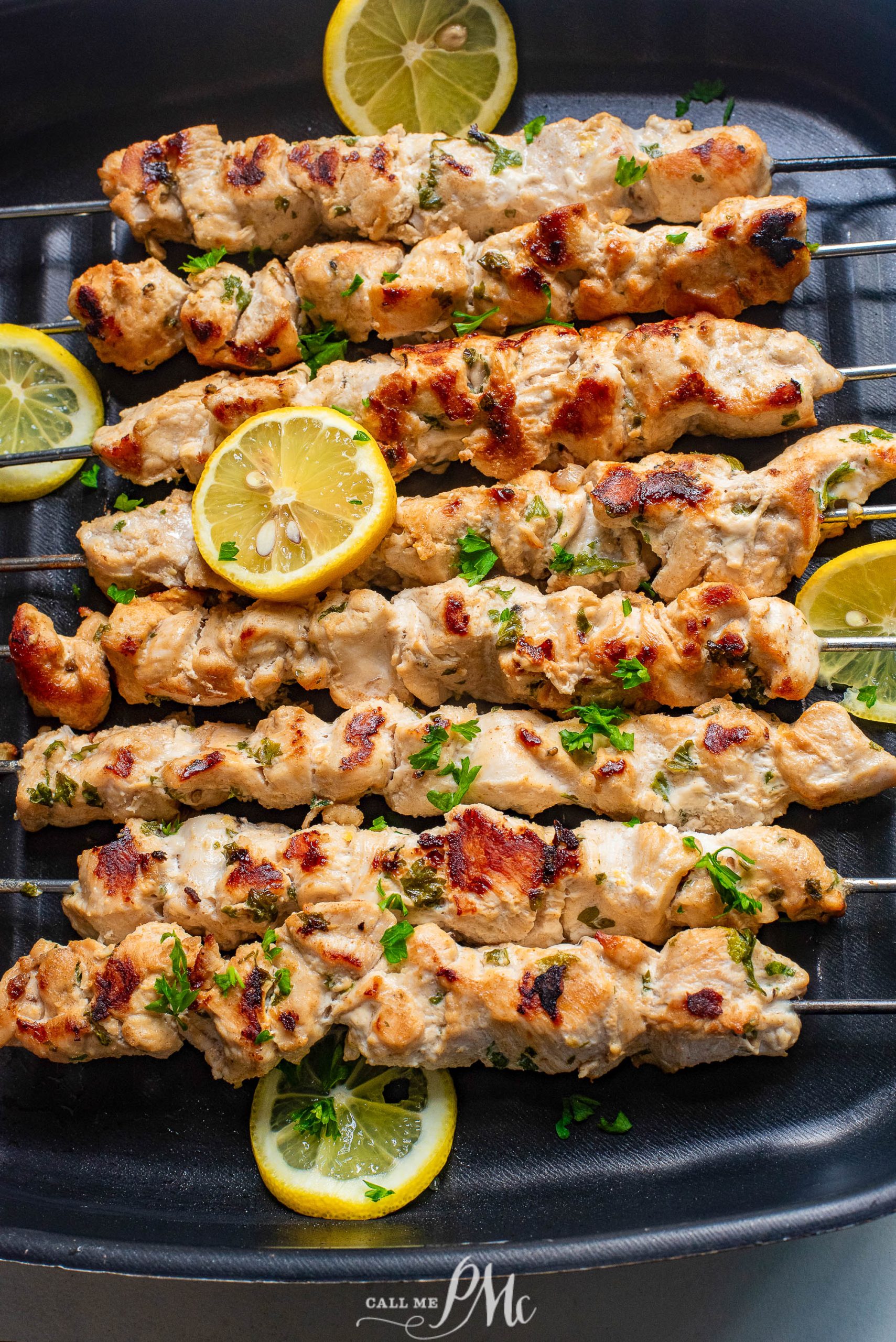 🎉Stovetop Chicken Souvlaki on a grill with lemon wedges.