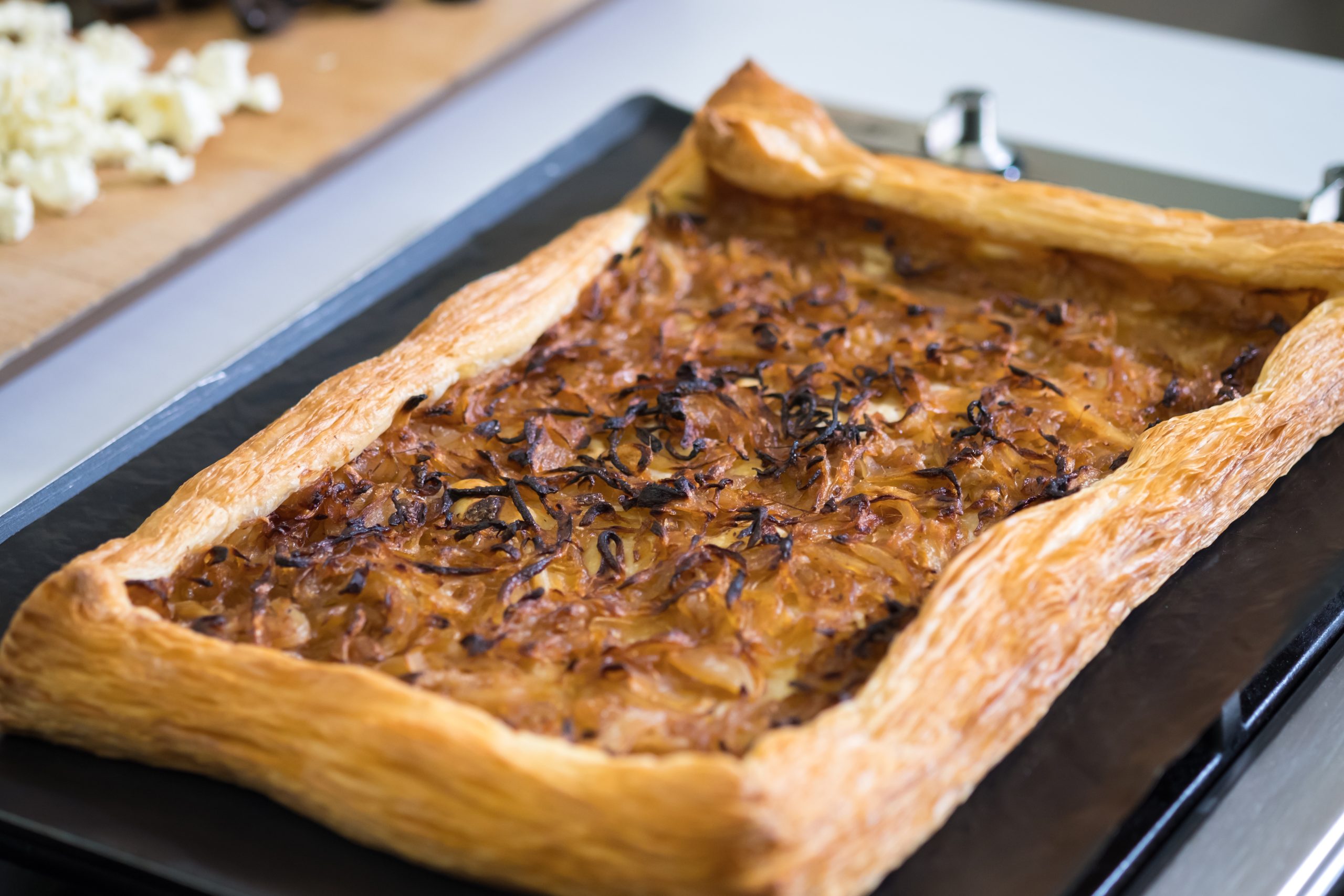 A tart is sitting on a baking sheet.