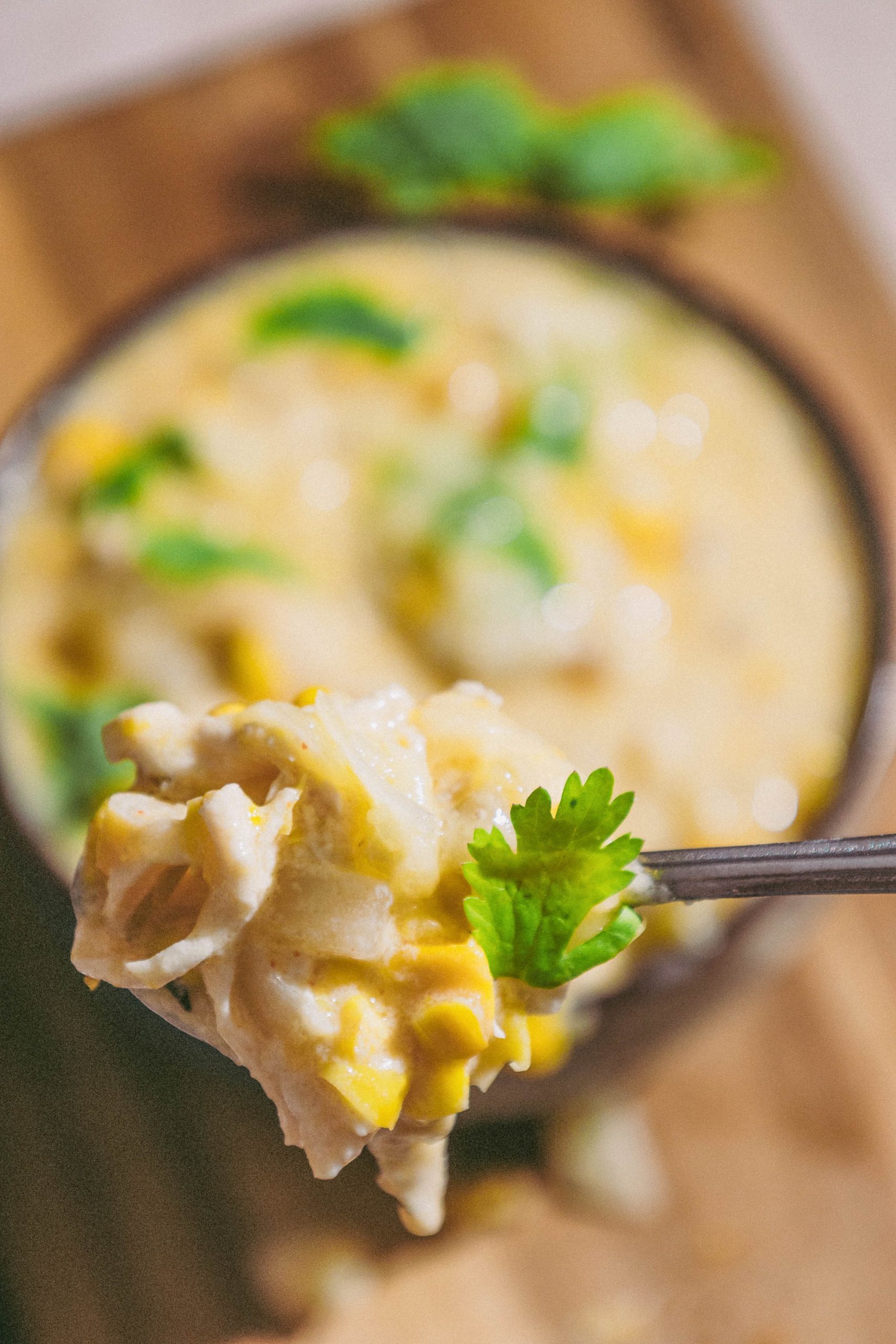 A fork is holding Green Chili Chicken Corn Chowder