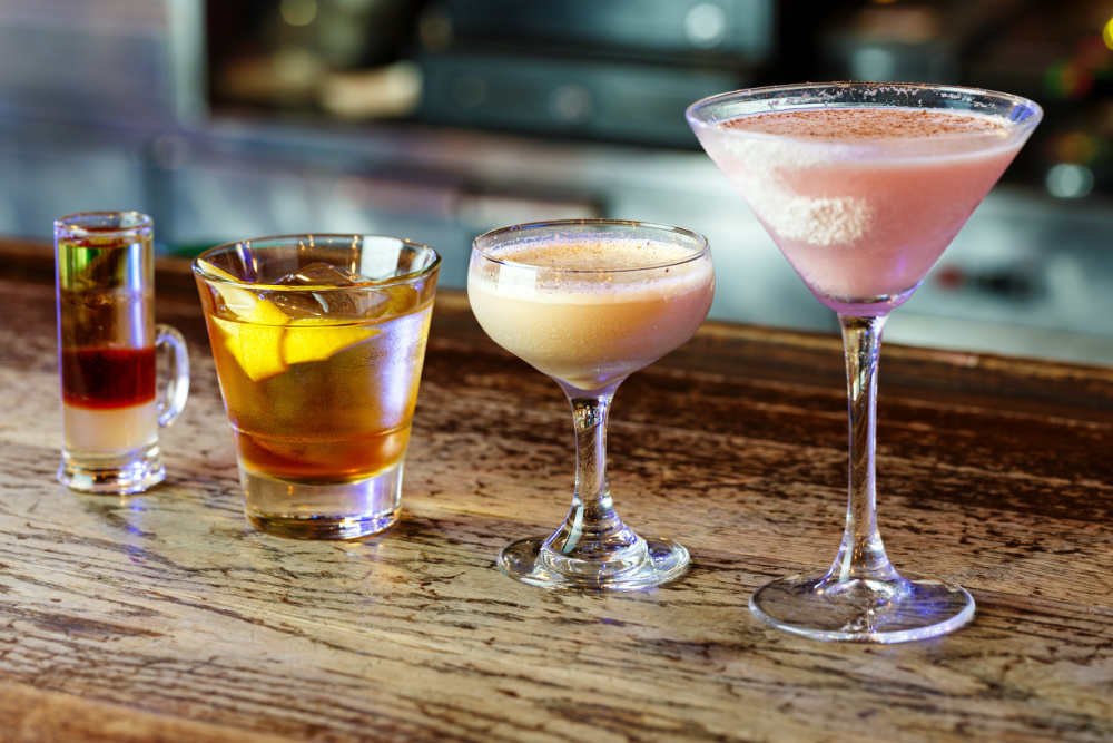 A group of drinks on a wooden table.